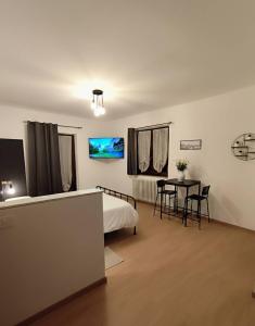 a bedroom with a bed and a table with chairs at La Dimora di Alma in Clivio