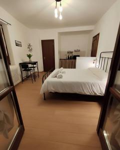 a bedroom with a bed and a table and chairs at La Dimora di Alma in Clivio