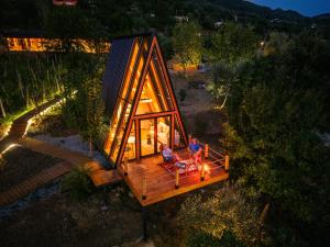 an overhead view of a tiny house with two people sitting on a couch at Funky Cabins Villas and Chalets - Gaia Park in Tirana +19 photos