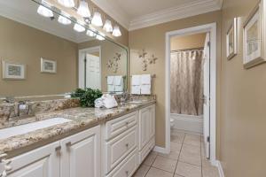 a bathroom with two sinks and a large mirror at Phoenix VI 61509 in Orange Beach +56 photos