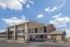 an image of a building with bikes parked outside at Best Western Caprock Inn in Brownfield