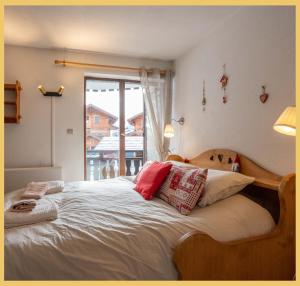 a bedroom with a large bed with pillows on it at Chez Candide I Studio I Montriond in Montriond