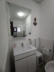 a white bathroom with a sink and a mirror at AL Vila Lina in Termas de Sao Pedro do Sul +32 photos