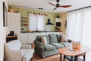 a living room with a couch and a table at Tims Vista Bella - Mezzegra, Tremezzina by LoveComo in Lenno
