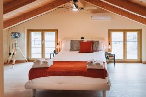 a bedroom with a large bed with towels on it at Tims Vista Bella - Mezzegra, Tremezzina by LoveComo in Lenno +16 photos