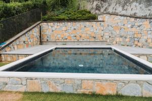 a pool of water in a stone wall at Tims Vista Bella - Mezzegra, Tremezzina by LoveComo in Lenno