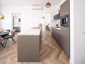 a kitchen with a counter and a dining room at Harderwold Villa - 551 in Zeewolde
