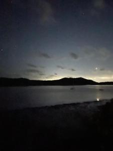 a view of a lake at night with the sky at Salt and Sea-renity in Russell Island +4 photos