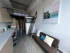 a living room with a couch and a loft bed at Atom Cuatro 303 in Guatemala