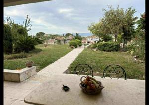 a table with a bowl of fruit on it at Villa Paliouri in Paliouri