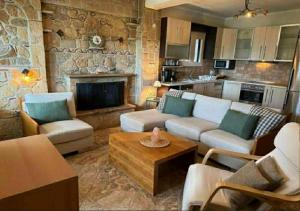 a living room with a couch and a fireplace at Villa Paliouri in Paliouri