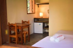 a small room with a table and a table and chairs at Hospedaria Lunar in Palmeiras