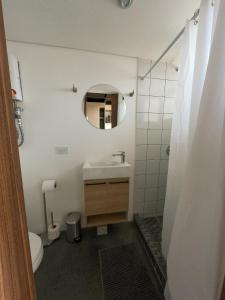 a bathroom with a sink and a toilet and a mirror at Atom Cuatro 303 in Guatemala +14 photos
