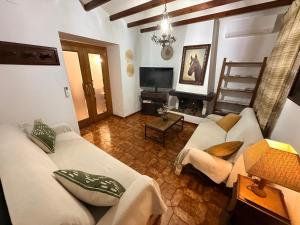 a living room with a couch and a tv at A R Benjamín in Artana