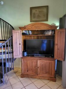 a tv on a wooden entertainment center with a flat screen at Molokai Kepuhi Beach Gem in Kepuhi +15 photos