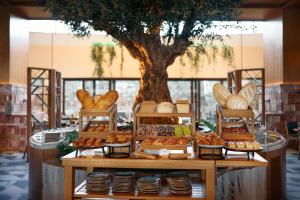 a table with different types of bread and pastries at The St. Regis Cap Cana Resort in Punta Cana