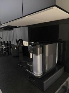 a kitchen with a coffee maker on a counter at La Priva House in Charleroi +17 photos