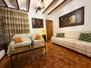 a living room with two couches and a table at A R Benjamín in Artana