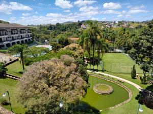 an aerial view of a park with a pond and trees at Piemonte Flat Serra Negra in Serra Negra +5 photos