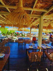 an empty restaurant with tables and chairs and umbrellas at Sharm Hills Azure Paradise in Sharm El Sheikh