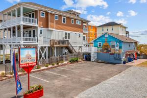 a building with a sign in a parking lot at Vitamin Sea Suites 3 in Carolina Beach
