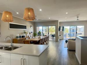 a kitchen and living room with a dining room at Aldinga Beach Reef Escape in Aldinga Beach