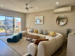 a living room with a couch and a table at Aldinga Beach Reef Escape in Aldinga Beach +22 photos