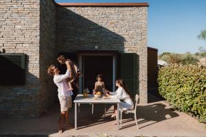 a group of people standing around a table at ReBi Village in Imperia +158 photos