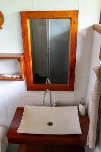 a bathroom with a sink and a mirror at Coati Lodge Misahualli in Tena +12 photos
