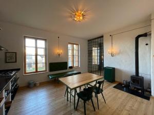 a living room with a table and chairs in it at Hydra - Gutshaus Bückling in Rambin +18 photos