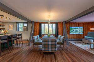 a living room with a table and chairs at La Tourelle Inn & Spa in Ithaca