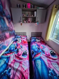 a bedroom with two beds and a child in a room at Hills residence in Morecambe