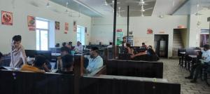 a group of people sitting at tables in a restaurant at Hotel Shree Ram in Kishangarh