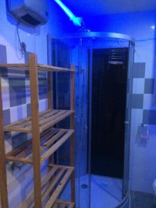 a shower with a glass door in a room at Studio sur agde, avec cour, parking et spa en option à 30e par jour in Agde