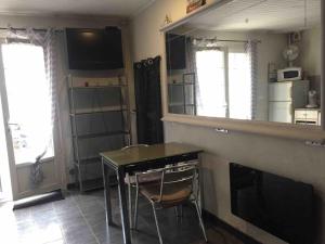 a kitchen with a counter and a table and a fireplace at Studio sur agde, avec cour, parking et spa en option à 30e par jour in Agde