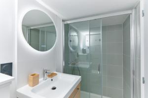 a bathroom with a sink and a shower at Charmant T2 - 2min de Lille in Ronchin +21 photos