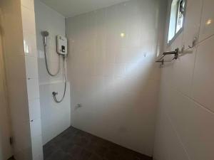 a bathroom with a shower stall with a window at M&M Kata Beach in Kata Beach