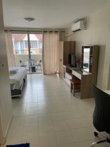a large room with a bed and a kitchen with at M&M Kata Beach in Kata Beach