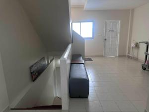 a living room with a black couch in a stair case at M&M Kata Beach in Kata Beach