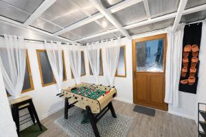 a room with a foosball table in the middle at Maison Connectée Serenia in Méru