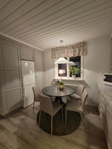 a dining room with a table and chairs at RåneVillan in Råneå +8 photos