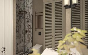 a bathroom with a toilet and a window with shutters at Oficyna Drukarza in Wschowa