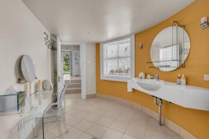 a bathroom with a sink and a mirror at Castle by the Sea - Tilba Road 26 in Bermagui +31 photos