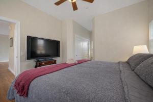 a bedroom with a large bed and a flat screen tv at Healdsburg Wine Country Escape with Tasting Perks & Vineyard Views in Healdsburg