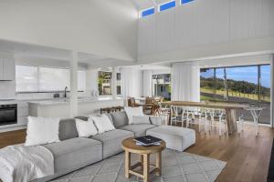 a living room with a couch and a table at Fishers - Scenic Drive 35 in Bermagui