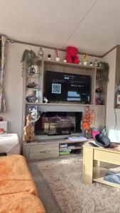 a living room with a entertainment center with a flat screen tv at Hills residence in Morecambe