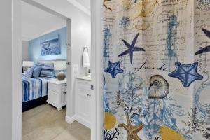 a bedroom with a shower curtain with stars on it at Oceanfront Condo #507 at Summit Beach Resort in Panama City Beach +53 photos