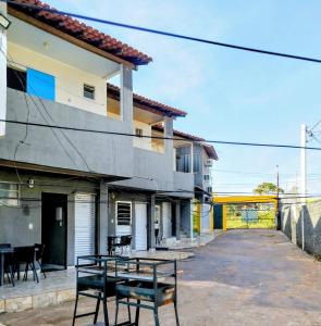 a building with a table in front of it at Temporada no Atalaia in Salinópolis