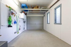 an empty garage with a garage door in a room at Koala Lodge Cottage 5 in Iluka