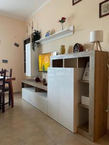 a kitchen with white cabinets and a table at Il Tramonto in Altino